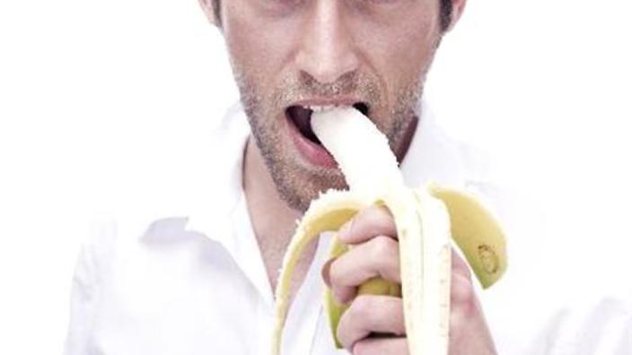 portrait_of_a_young_man_eating_a_banana_bmf00346