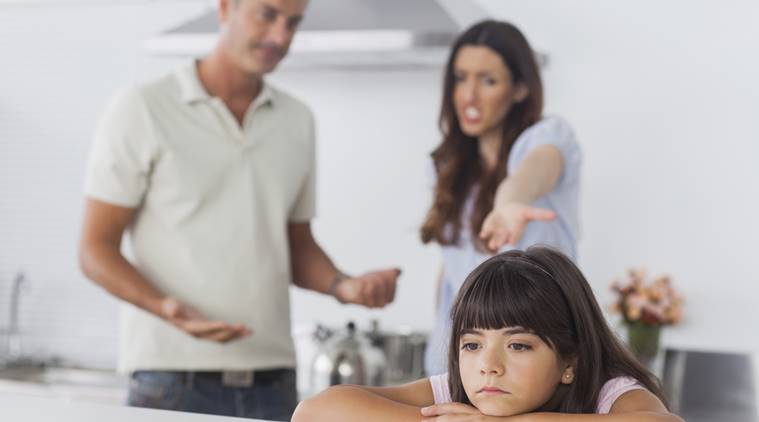 Couple having dispute in front of their upset daughter